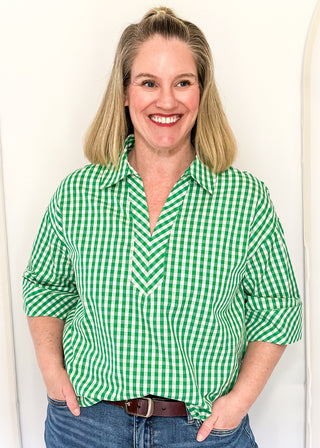 Gingham blouse with split neckline, collar, and 3/4 sleeves.
