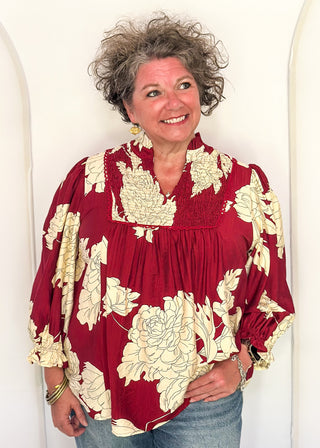 woman in longsleeve burgundy floral top