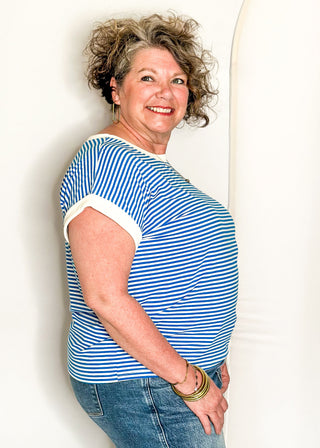 Blue and white striped short sleeve top with white banding on sleeve and collar. 