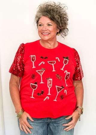 woman modeling a short sleeve red sequin sleeve top with sequin drinks on the front. 