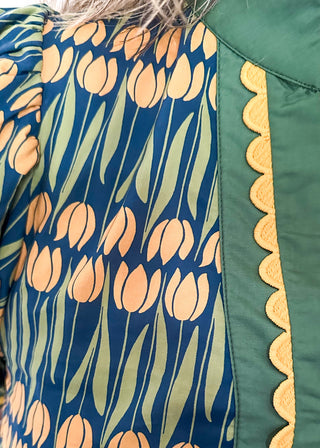 Large puff sleeve top with golden tulips and green leaves.  Contrast is green with yellow scallop detail-short sleeve and v-neck.