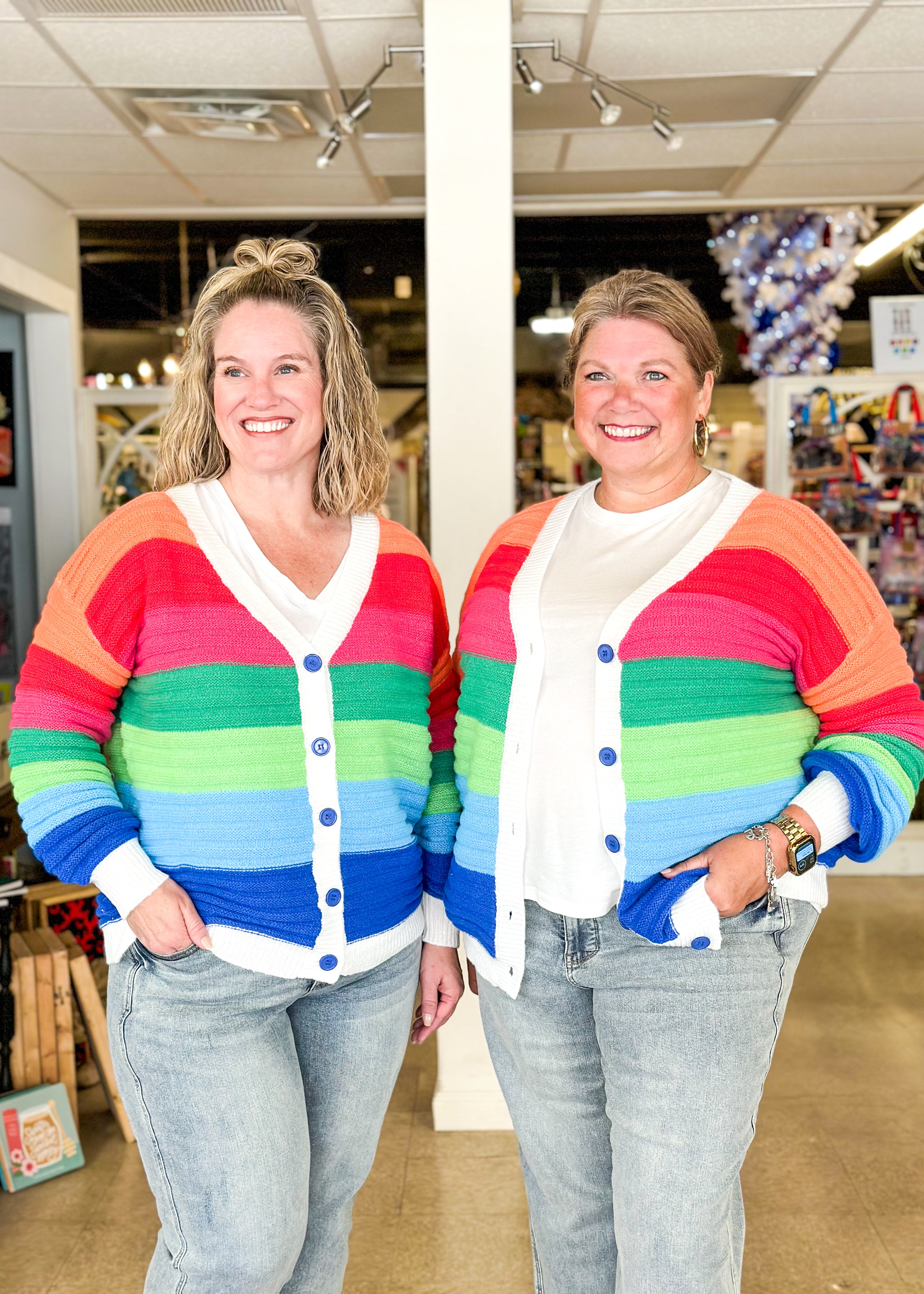 striped rainbow cardigan with blue buttons and white trim, wide stripes in orange, red, pink, green, light green, light blue and blue