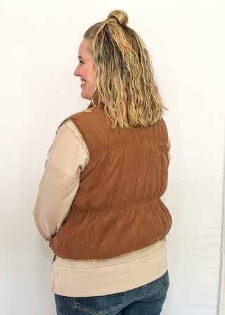 Reversible puffer vest with red and pink floral on one side, brown corduroy on the other.  Pockets on both sides, collared with zipper closure.