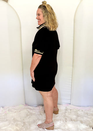 1/2 zip collared black knee length dress. Elastic collar and sleeve in cream and black. Short Sleeve