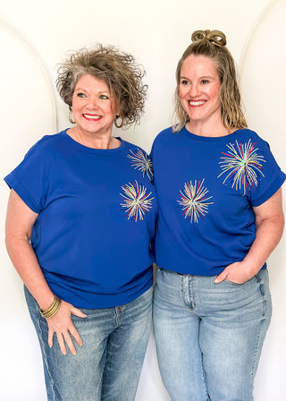 blue short sleeve top with 2 sequin firework bursts.