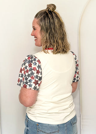 Sequin Flag with red and blue sequin star sleeves and red contrast banding on collar. 