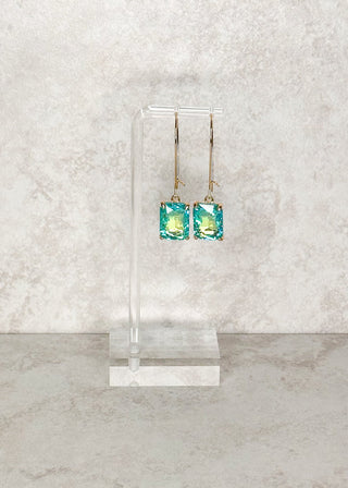 Rectangle Gemstone dangle earrings in Aqua. Displayed on a stand  
