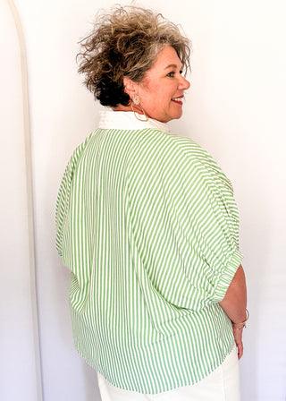 Striped seersucker top in green and white with short sleeves, relaxed fit, and split neckline.