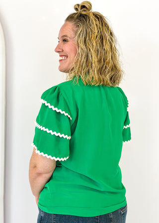Kelly Green puff sleeve top- 3 tiered white rick-rack Trim on sleeves-
Ruffle Collar, V-neck.  