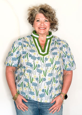 Spring floral top with short sleeves, easy silhouette, and colorful blue and green pattern.