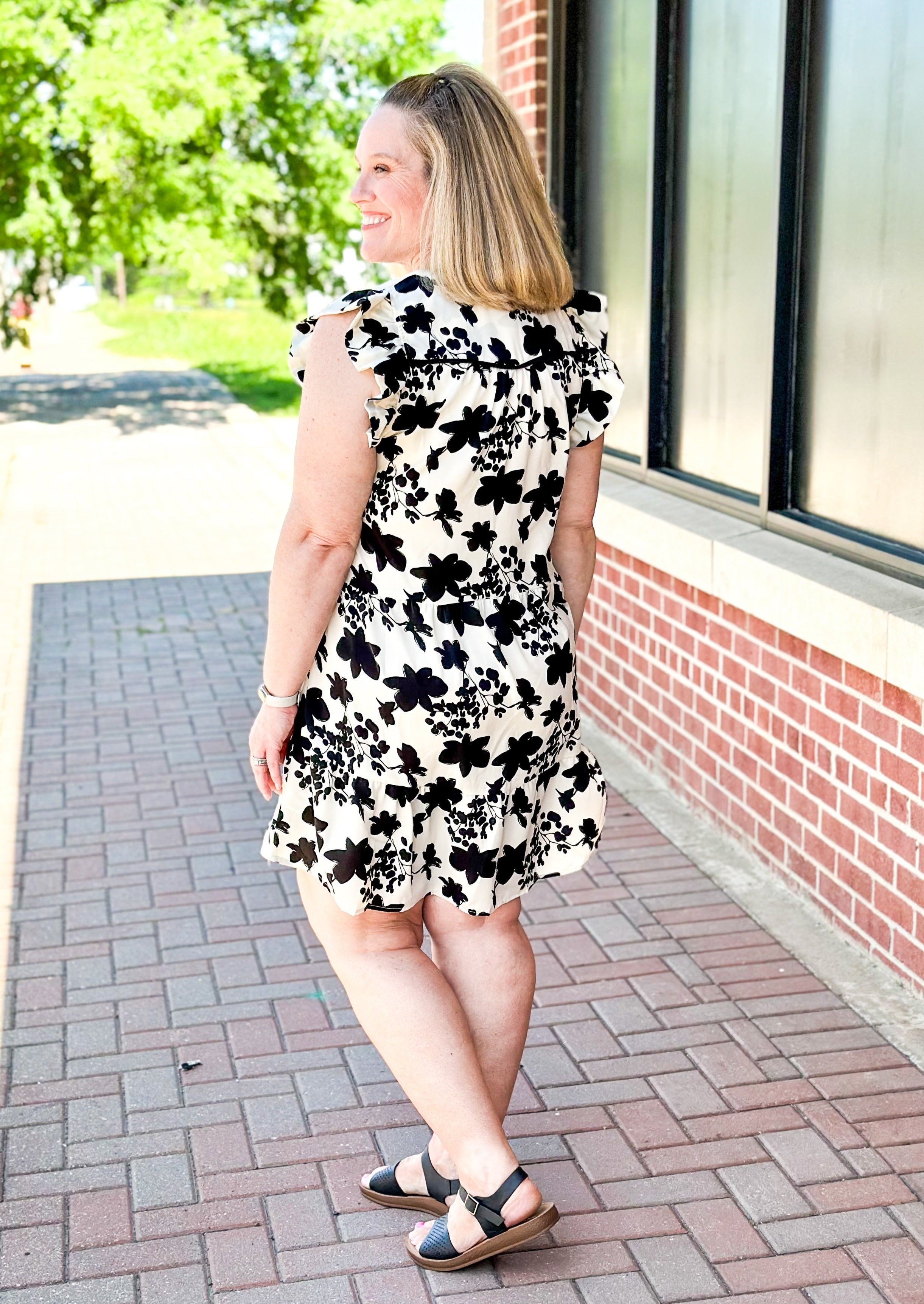 Cream with black floral pattern dress - short ruffle sleeve - v-neck - tiered - black piping just below bust