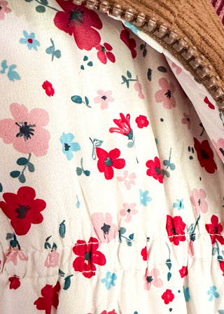 Reversible puffer vest with red and pink floral on one side, brown corduroy on the other.  Pockets on both sides, collared with zipper closure.