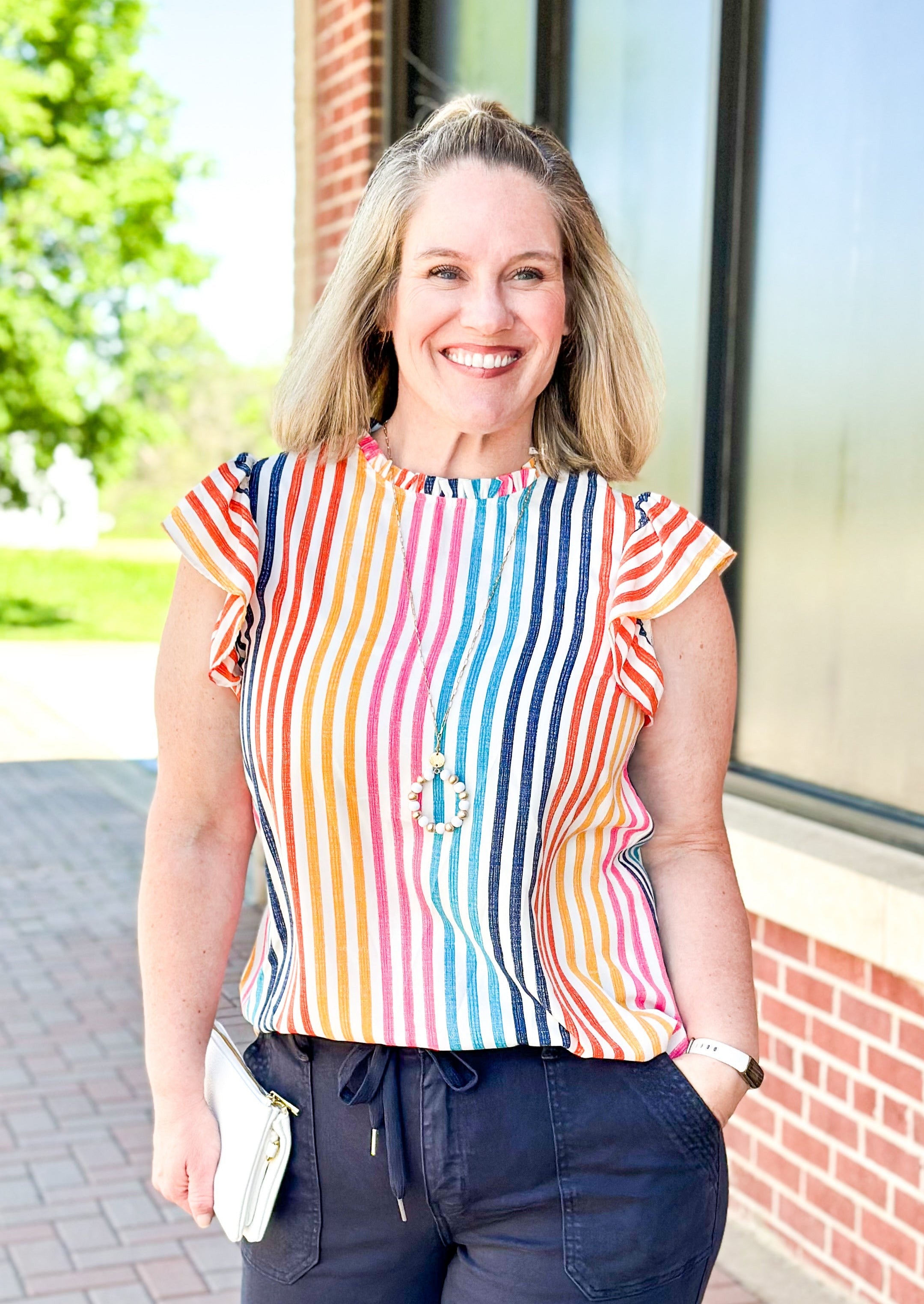 vertical striped top with ruffle sleeve and neck - keyhole back with button closure - ruffle sleeve - stripes pink, navy, light blue, yellow