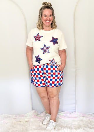 Red, white, and blue checkered shorts with drawstring elastic waist and pockets.