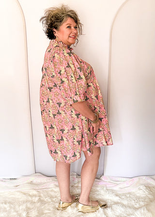 Pink floral short sleeve dress with lined construction, ruffle collar and puff sleeve. 