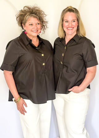 Collared black blouse with detailed gold snaps. short sleeve