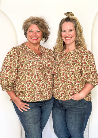 Corduroy texture with a beige background and dusty pink and maroon florals.  Multi tie closure in the front and 3/4 sleeve.