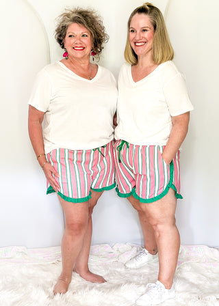 Pink and green striped ruffle hem shorts with elastic waistband, pockets, and drawstring for women