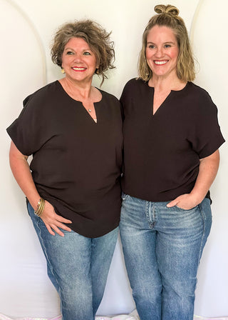 Solid black textured blouse with a V-notch neckline, short sleeves