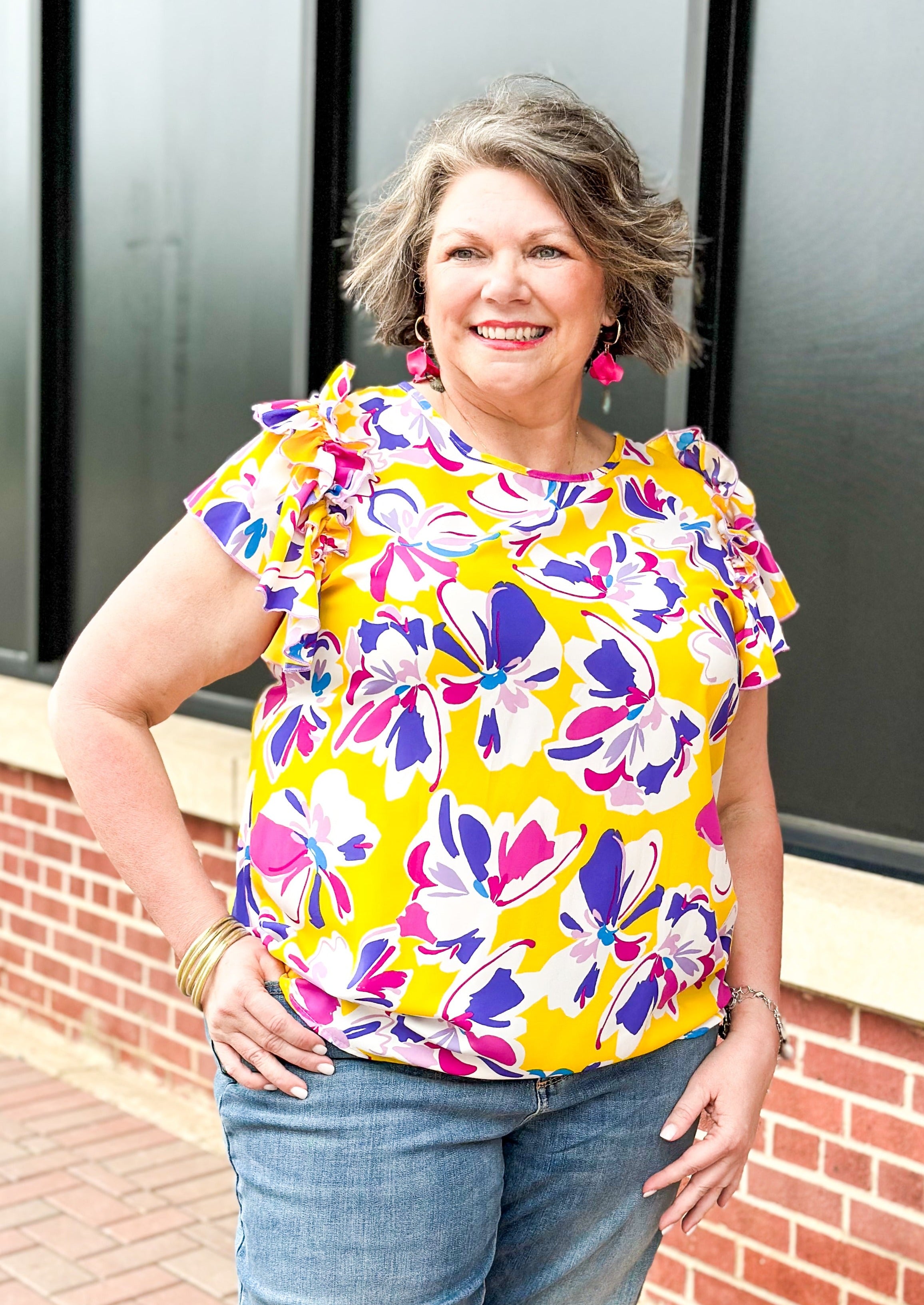 Purple and pink flowers on a yellow top with double ruffle sleeve