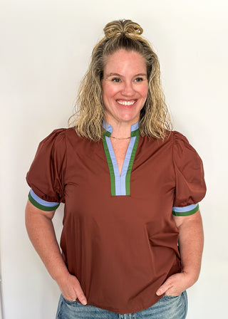 Brown Puff Sleeve top with short sleeves and v-neck.  Contrast binding in green and blue on sleeve and collar. 