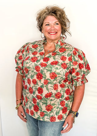 Light Pink short sleeve top, v-neck with ruffle detail.  Elastic detail on the sleeve.  Large Rose pattern with jade leaves. 