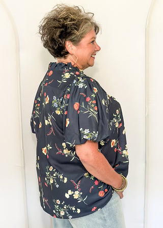 side view of woman in Navy flower blouse
