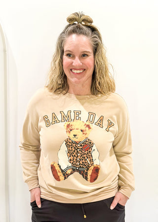 Tan long sleeve pullover with "GAME DAY" in arched bold lettering above Benny the Bear in his leopard letterman jacket.  