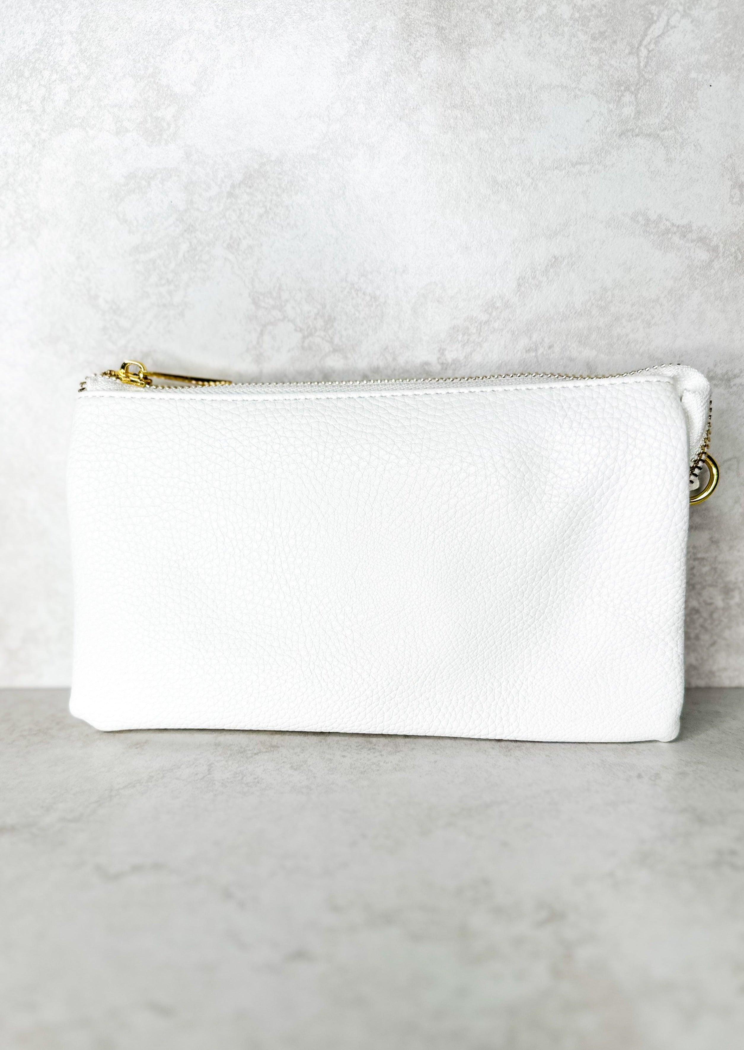 Crossbody bag with zipper, gold hardware, pockets inside, comes with wrist strap and shoulder strap, both straps removable - white