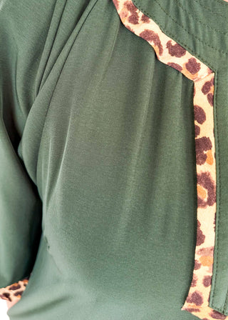 Knee length dark green dress with leopard detail around chest.  3/4 puff sleeve, split neckline, pockets. 