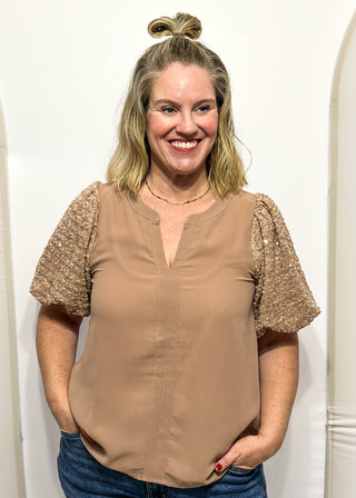 Rose-colored top featuring sparkly sequin puff sleeves and a relaxed, flowy body.