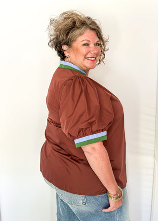 Brown Puff Sleeve top with short sleeves and v-neck.  Contrast binding in green and blue on sleeve and collar. 