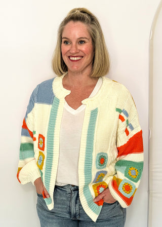 woman modeling a colorful sweater cardigan
