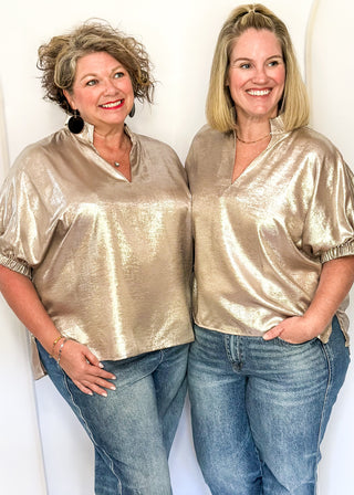 Shimmer Champagne V-neck blouse with relaxed elastic short sleeves and a split hem at waist. 