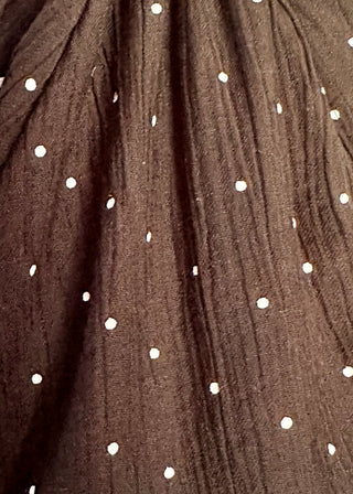 close up of black bubble hem long sleeve top with white dots.