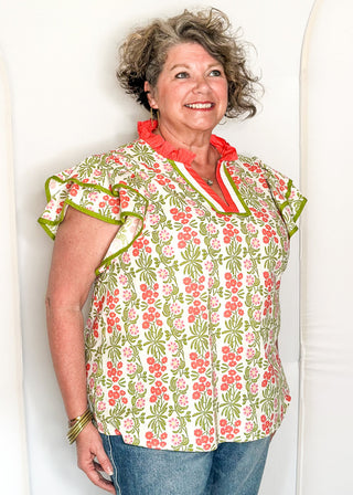 Floral print top with decorative neckline and short ruffle sleeves