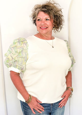 White ribbed knit top with pastel watercolor puff short sleeves. 