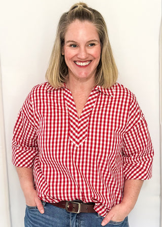 Gingham blouse with split neckline, collar, and 3/4 sleeves.