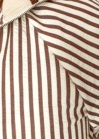 Short sleeve black and off white vertical stripes, zip front collar.  Collar and sleeve has contrast trim with bold stripe