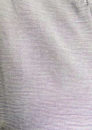Close up of solid textured blouse with a V-notch neckline, short sleeves