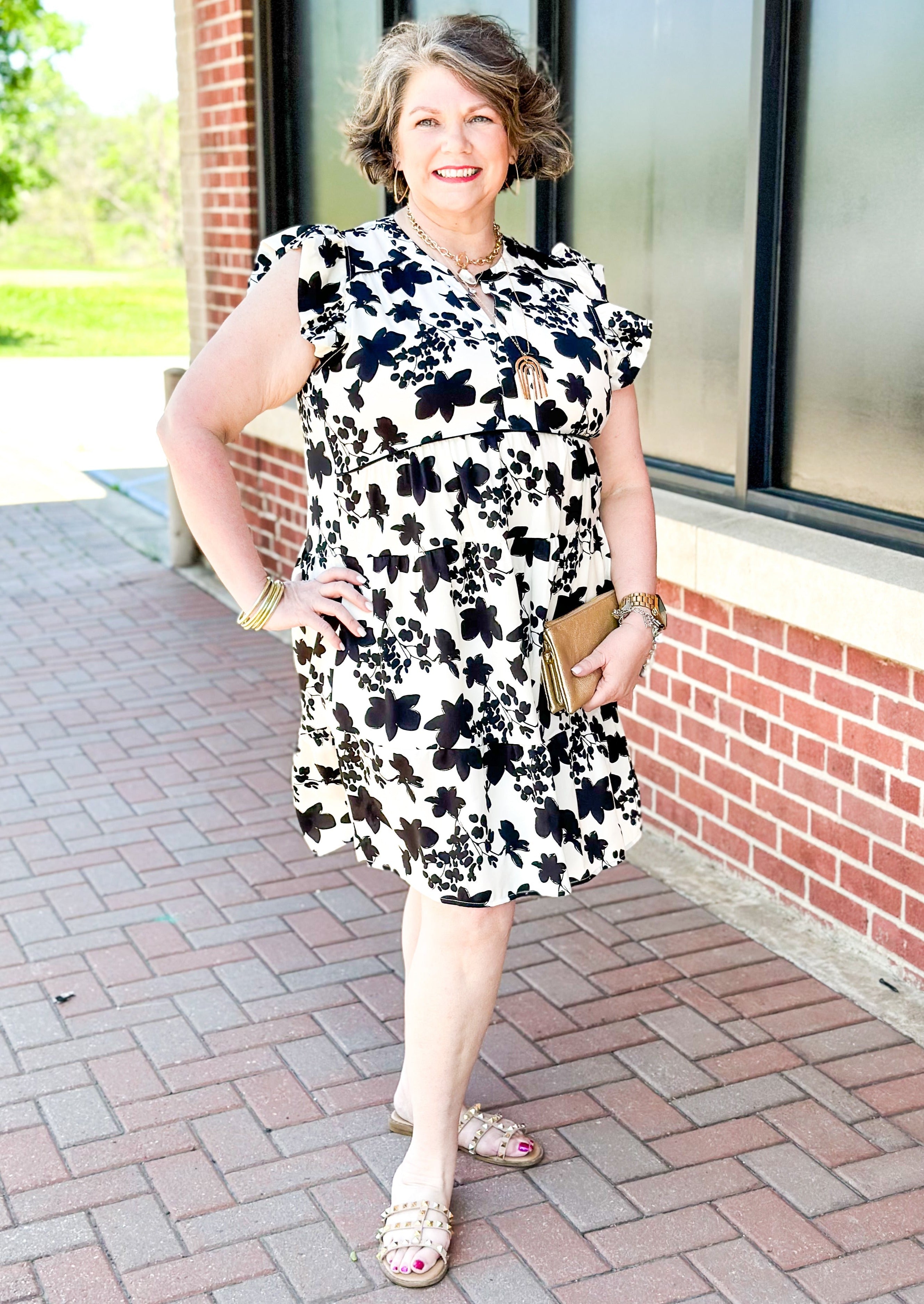 Cream with black floral pattern dress - short ruffle sleeve - v-neck - tiered - black piping just below bust