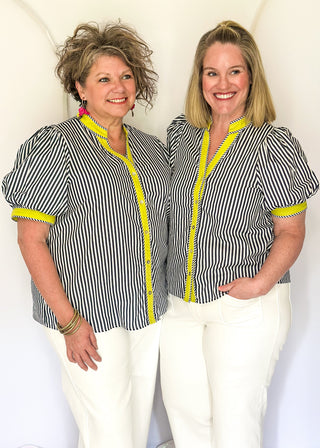 Striped button-down top with V-neckline, short puff sleeves, and contrast trim detailing