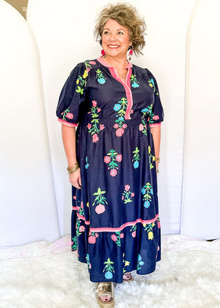 Colorful floral navy midi dress featuring pink contrast trim and a gathered waistline