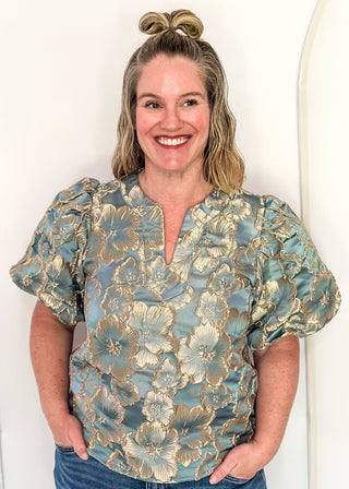 woman in jacquard floral puff sleeve top in Gold Marine.