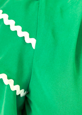 Kelly Green puff sleeve top- 3 tiered white rick-rack Trim on sleeves-
Ruffle Collar, V-neck.  