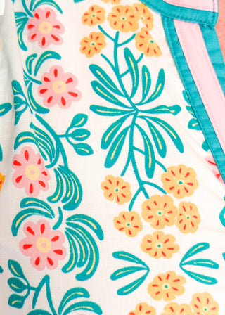 Close up of floral midi dress with contrast neckline, short puff sleeves, and tiered skirt