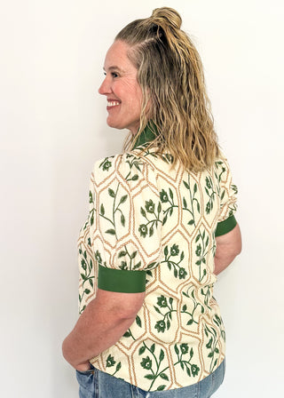 Neutral blouse featuring green florals with geometric hexagon pattern