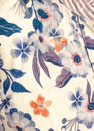 close up of women’s floral blouse with button front detail and lavender striped contrast accents