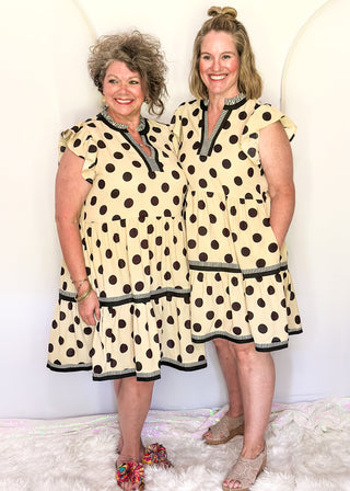 Cream flowy polka dot dress with tiered layers and contrast striped neckline detail