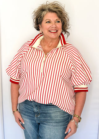 Women’s red striped short sleeve 1/4 zip top with lightweight fabric, stripe elastic sleeve and collar detail.
